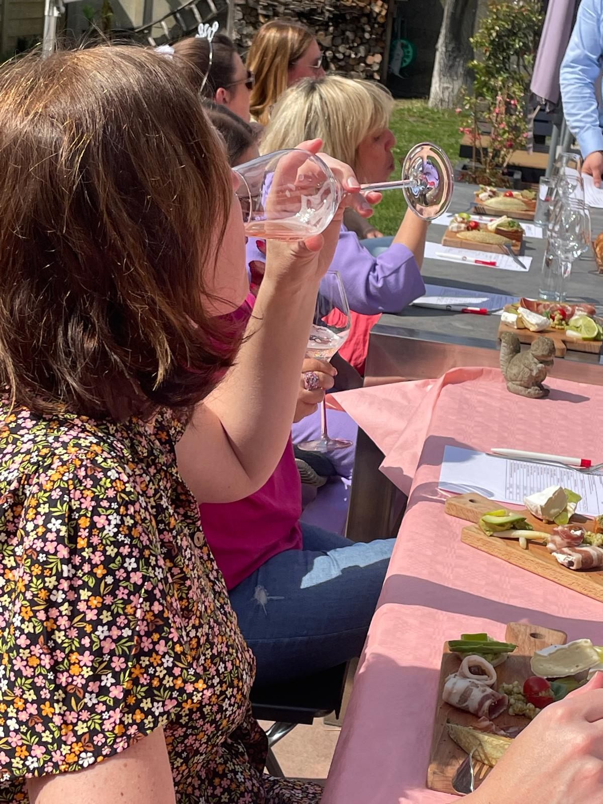 Gasten proeven rosé tijdens een zomerse wijnproeverij in de tuin
